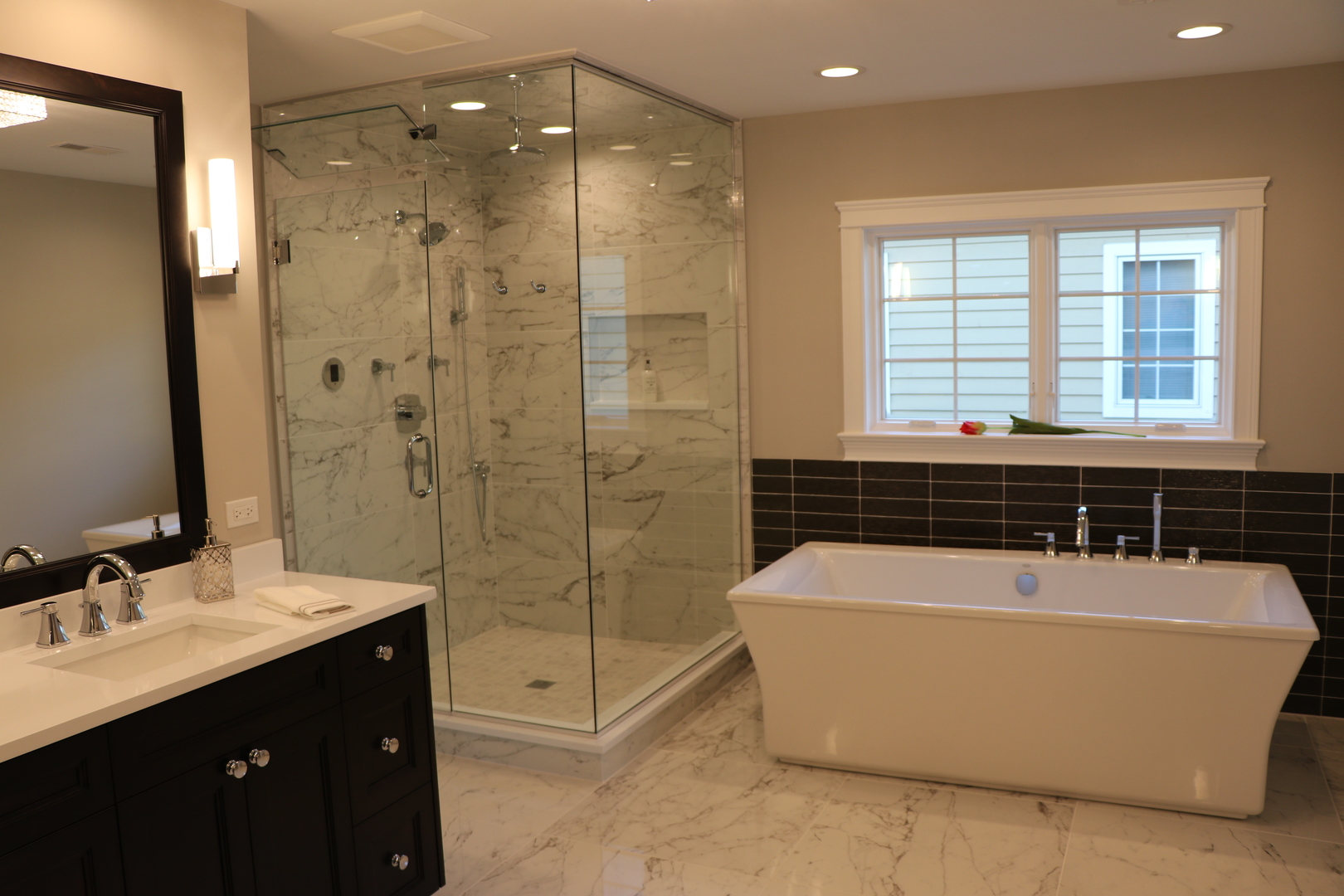 2247 Illinois Road Northbrook, IL 60062 - Photo 14 of 32 a bathroom with a bath tub a sink a window and a shower