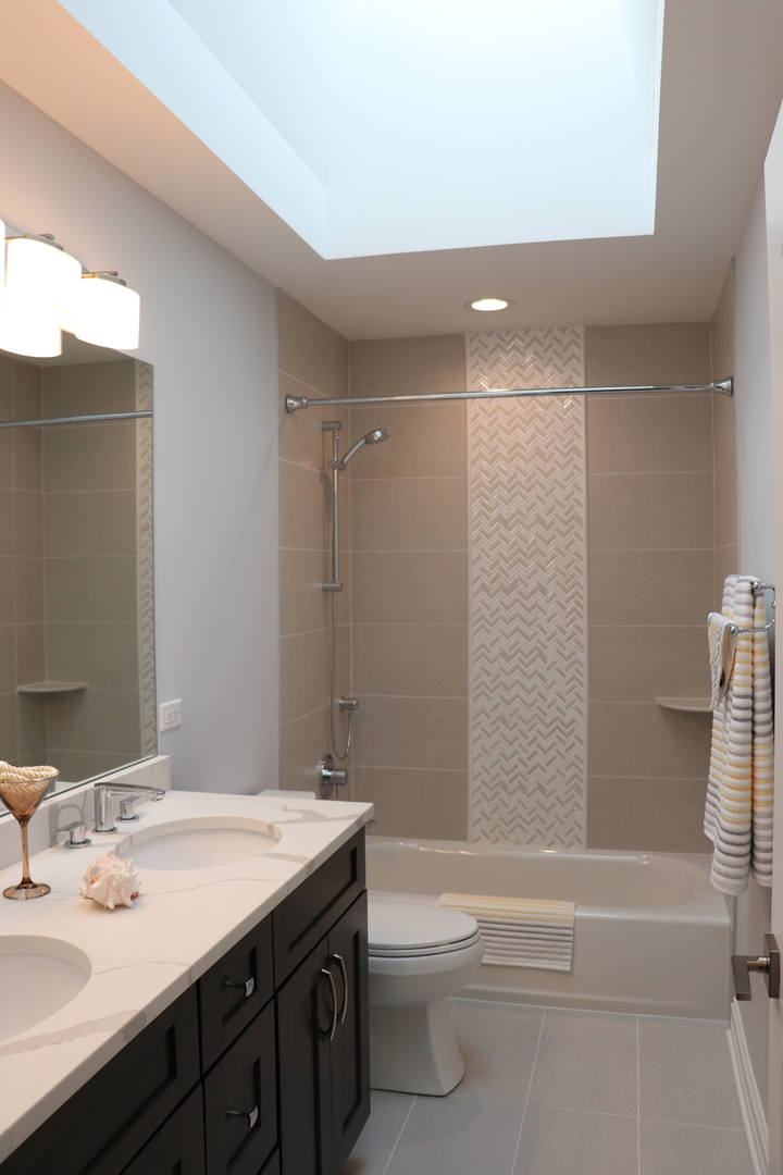 2247 Illinois Road Northbrook, IL 60062 - Photo 16 of 32 a bathroom with a granite countertop sink toilet and shower