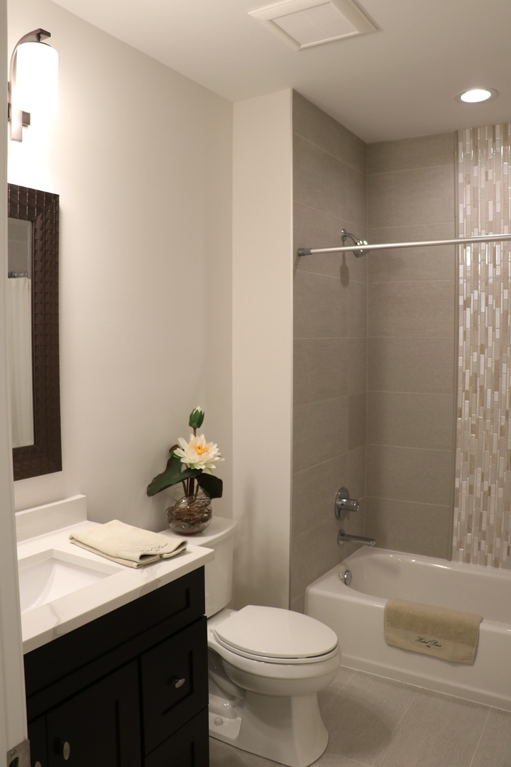 2247 Illinois Road Northbrook, IL 60062 - Photo 20 of 32 a bathroom with a granite countertop sink toilet and shower