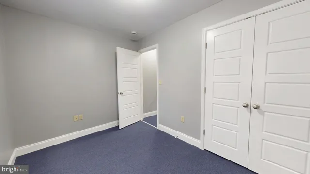 an empty room with closet area