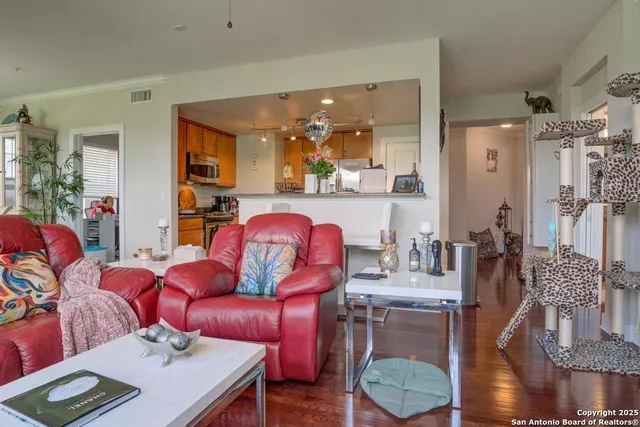 a living room with furniture and wooden floor