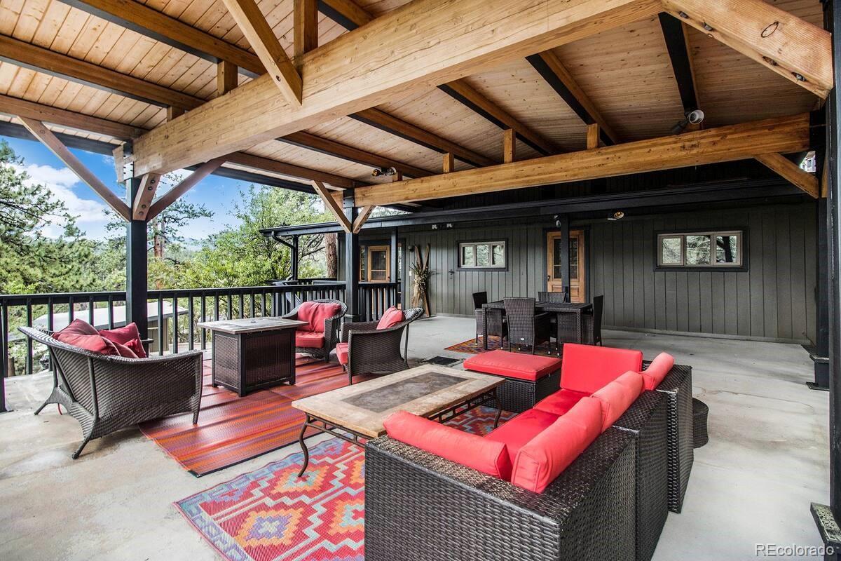 28433 Kinnikinnick Road Evergreen, CO 80439 - Photo 16 of 29 a outdoor space with the benches and a potted plant