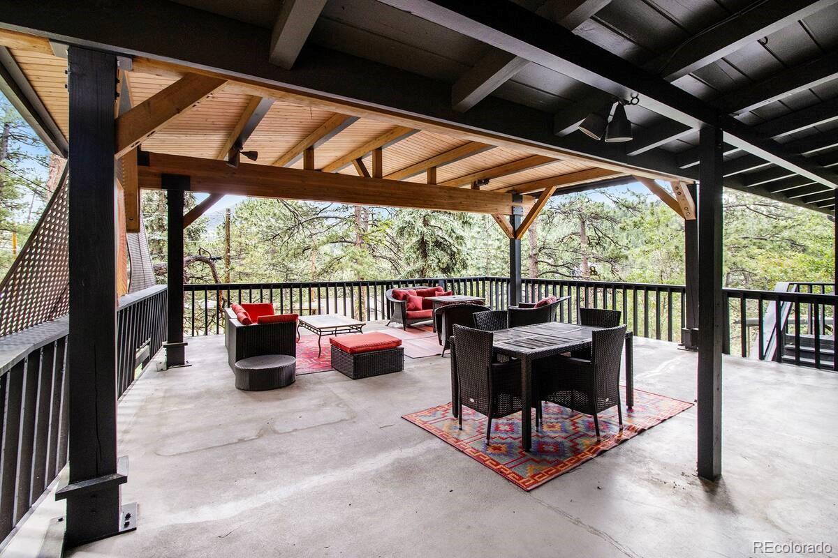 28433 Kinnikinnick Road Evergreen, CO 80439 - Photo 17 of 29 a building outdoor space with patio furniture and potted plants