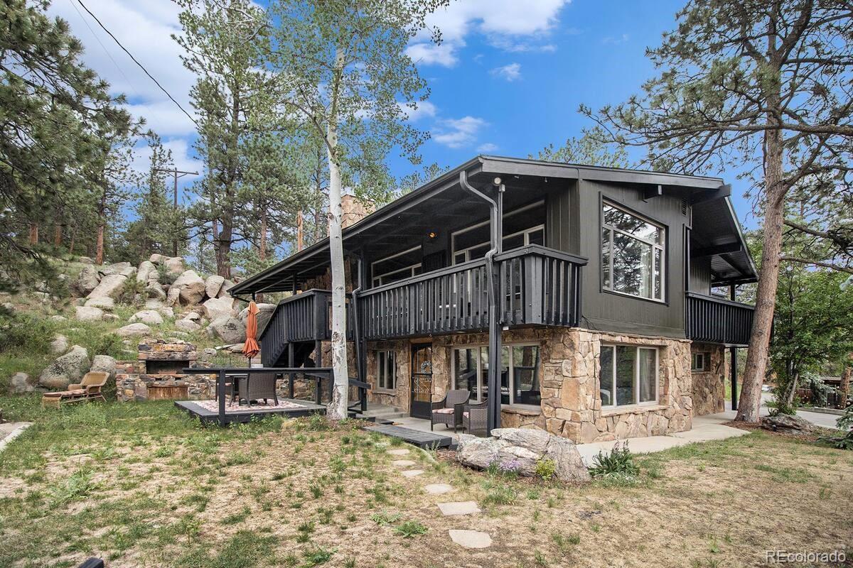 28433 Kinnikinnick Road Evergreen, CO 80439 - Photo 18 of 29 a front view of a house with garden