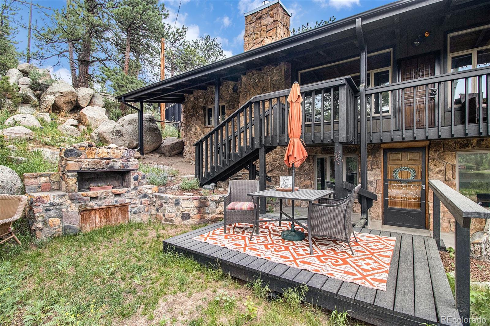 28433 Kinnikinnick Road Evergreen, CO 80439 - Photo 20 of 29 a view of house with roof deck and seating space
