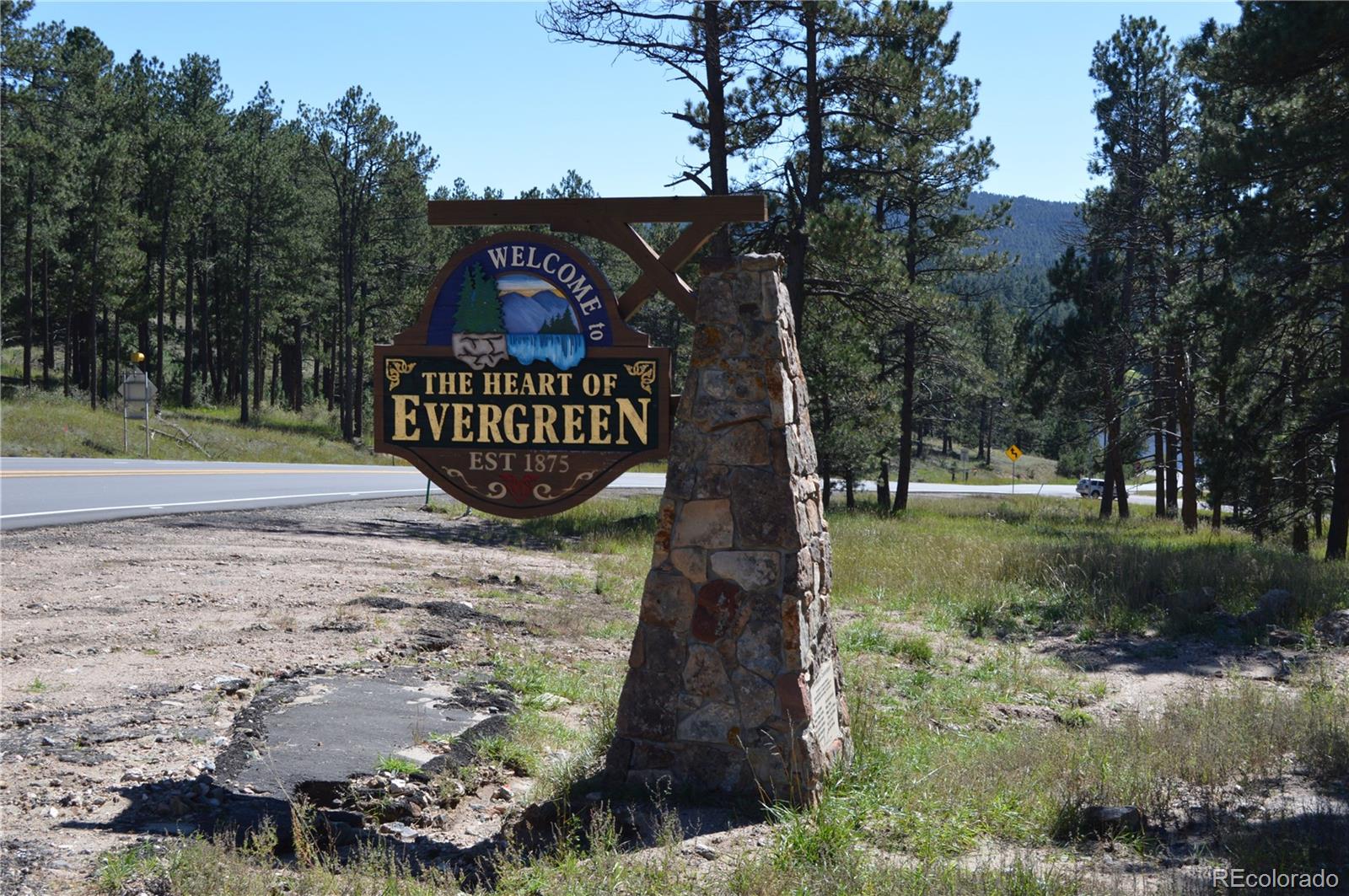 28433 Kinnikinnick Road Evergreen, CO 80439 - Photo 22 of 29 a view of a street with a tree in the background