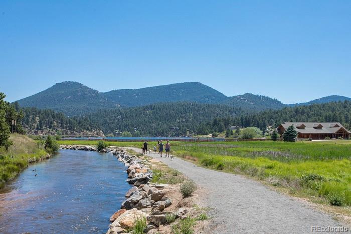28433 Kinnikinnick Road Evergreen, CO 80439 - Photo 26 of 29 a view of a town with mountains in the background