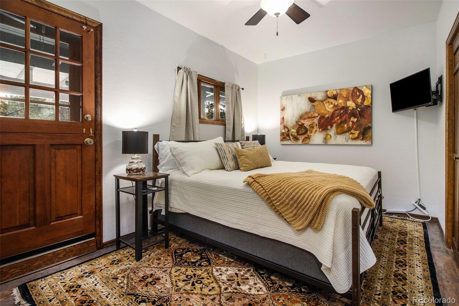28433 Kinnikinnick Road Evergreen, CO 80439 - Photo 10 of 29 a bedroom with bed and window