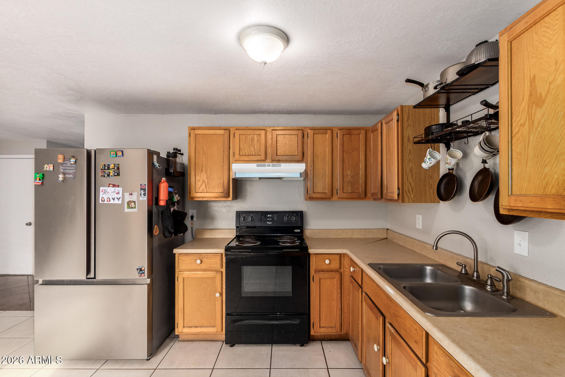 6423 West Almeria Road Phoenix, AZ 85035 - Photo 12 of 31 a kitchen with a sink a stove and refrigerator
