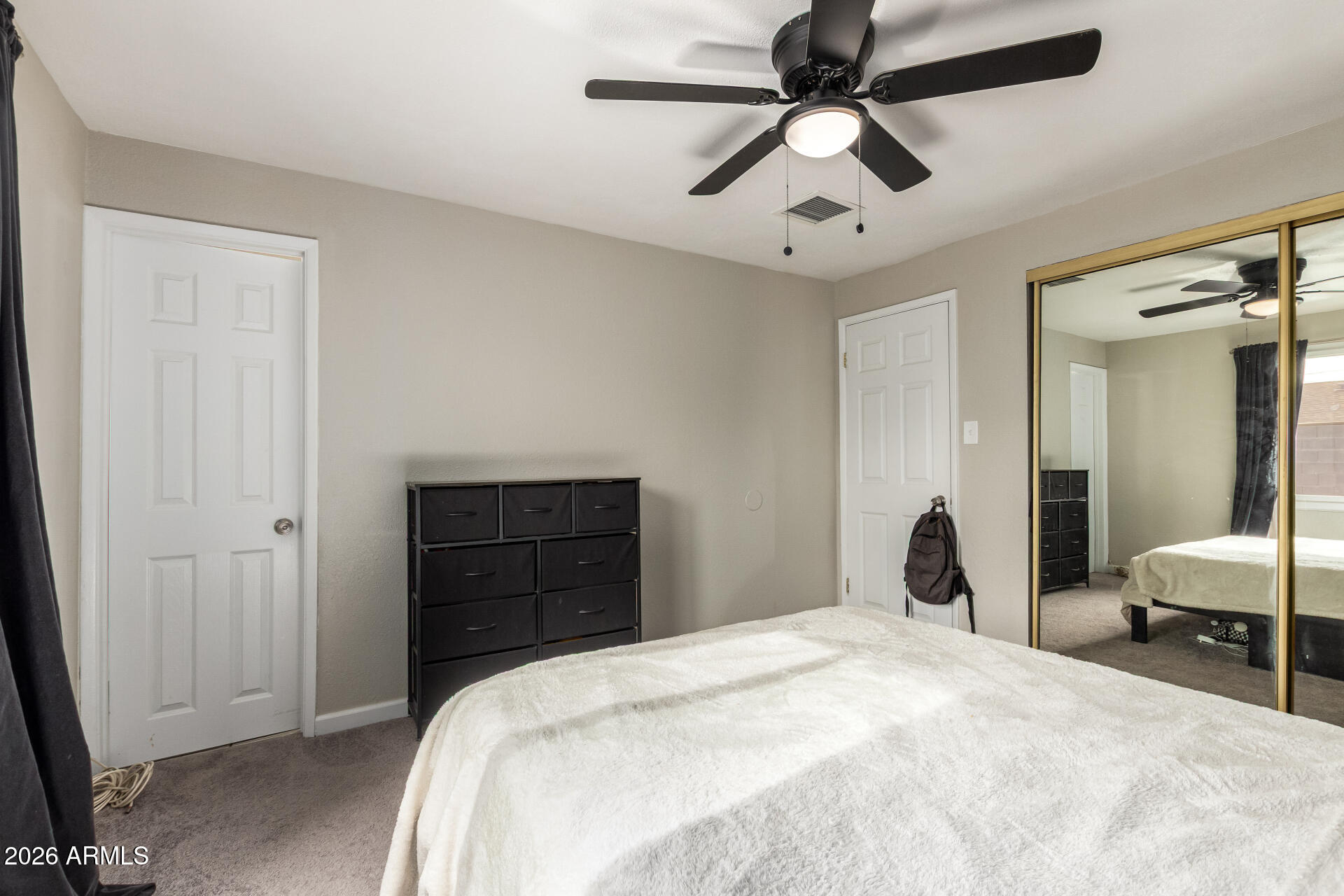 6423 West Almeria Road Phoenix, AZ 85035 - Photo 14 of 31 a bedroom with a bed and a closet