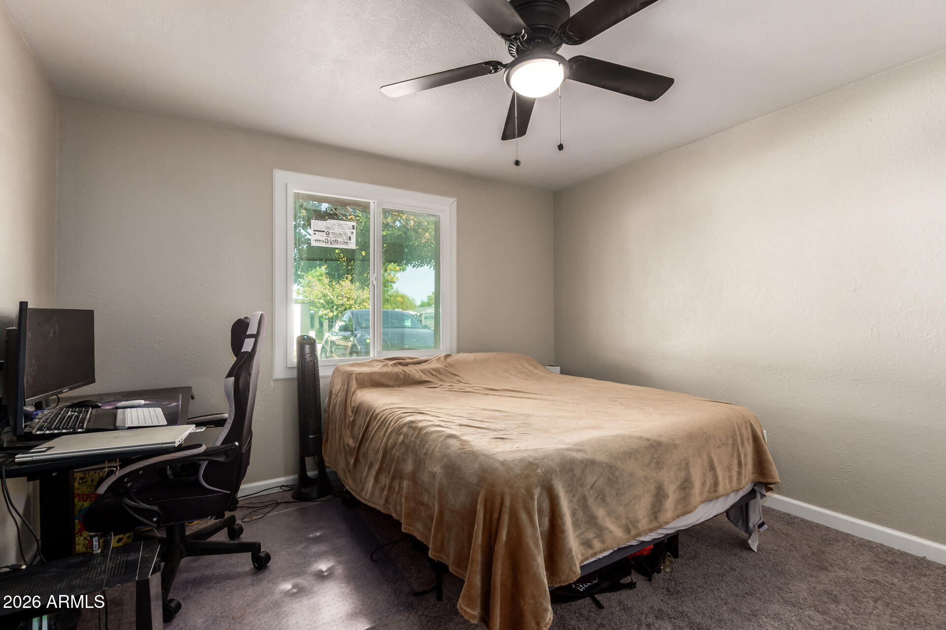 6423 West Almeria Road Phoenix, AZ 85035 - Photo 16 of 31 a bedroom with a bed and a window