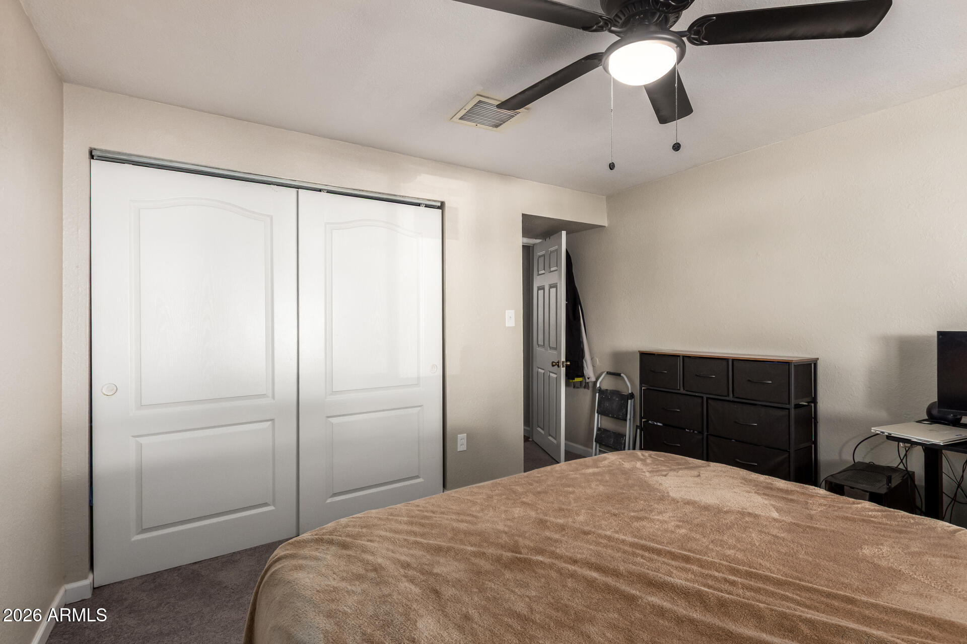 6423 West Almeria Road Phoenix, AZ 85035 - Photo 17 of 31 a bedroom with a bed and a dresser