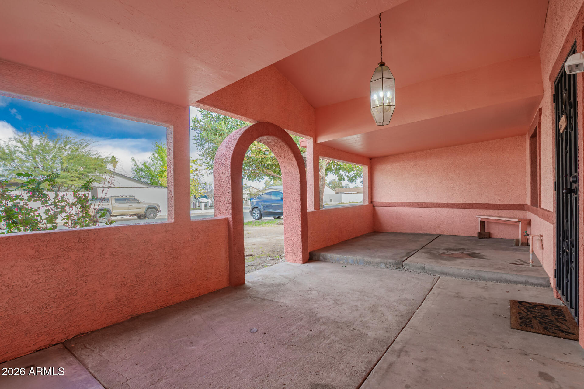 6423 West Almeria Road Phoenix, AZ 85035 - Photo 3 of 31 a view of an empty room with a fireplace and windows