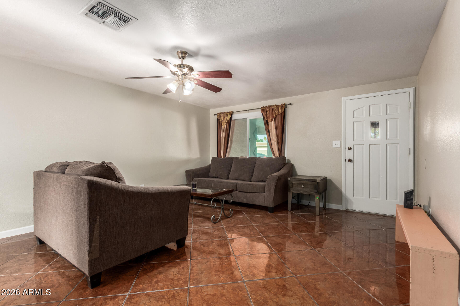 6423 West Almeria Road Phoenix, AZ 85035 - Photo 4 of 31 a living room with furniture and a ceiling fan