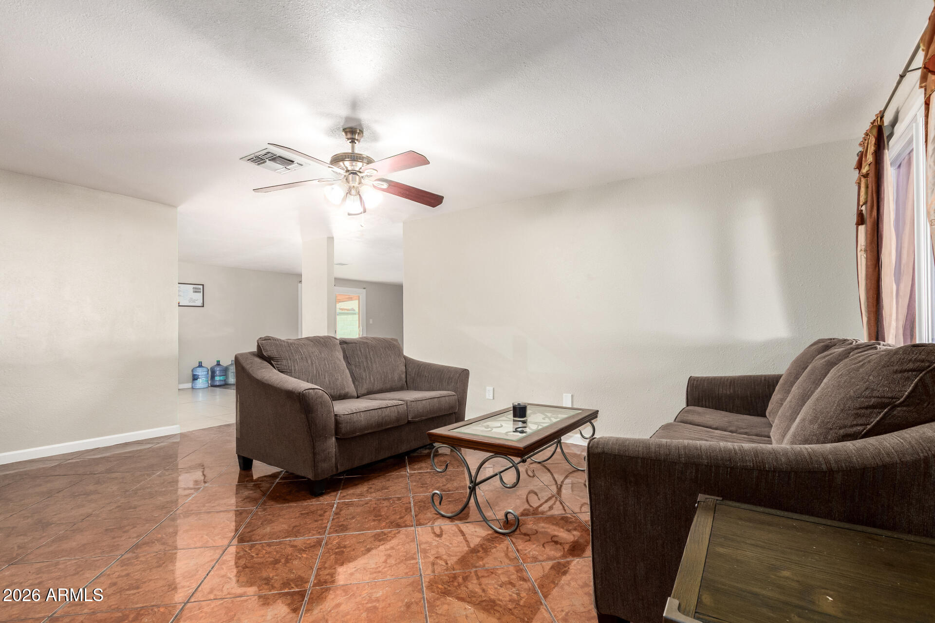6423 West Almeria Road Phoenix, AZ 85035 - Photo 5 of 31 a living room with furniture and a ceiling fan