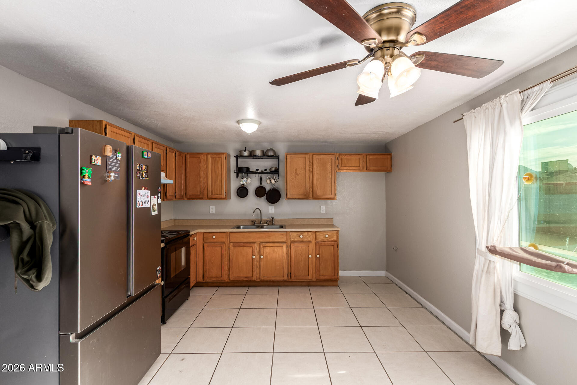 6423 West Almeria Road Phoenix, AZ 85035 - Photo 10 of 31 a kitchen with stainless steel appliances granite countertop a refrigerator and a sink