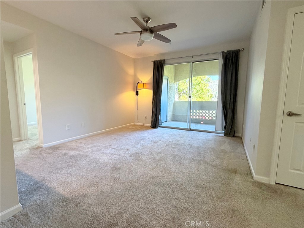 375 Central Avenue, Unit 14 Riverside, CA 92507 - Photo 10 of 32 a view of a livingroom with a ceiling fan and window