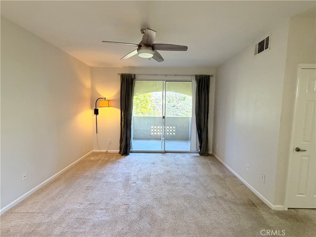 375 Central Avenue, Unit 14 Riverside, CA 92507 - Photo 9 of 32 an empty room with chandelier fan and windows
