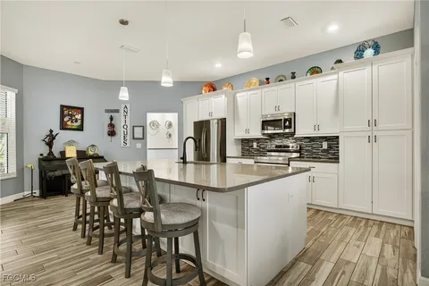 a kitchen with stainless steel appliances a refrigerator stove microwave and cabinets