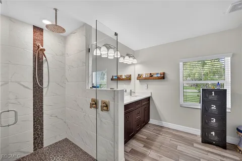 a view of kitchen with granite countertop cabinets and window