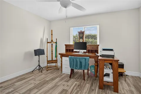 a workspace with furniture a rug and wooden floor