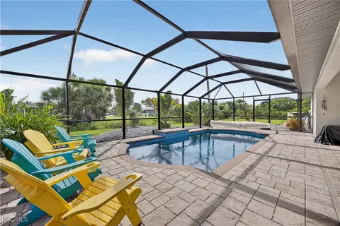 a view of swimming pool with seating area and roof