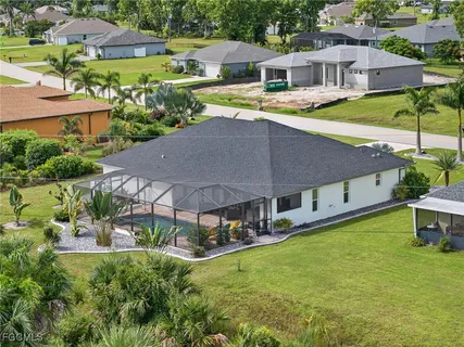 an aerial view of a house with swimming pool patio and outdoor seating