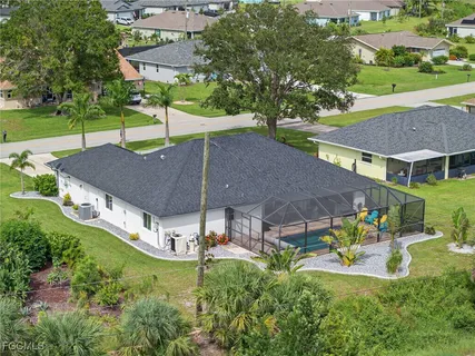 an aerial view of a house with swimming pool garden and patio
