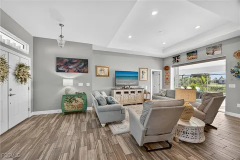 a living room with furniture and a wooden floor