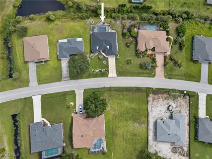 an aerial view of a house with outdoor space swimming pool