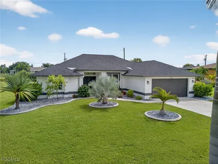 a view of a house with swimming pool and a yard