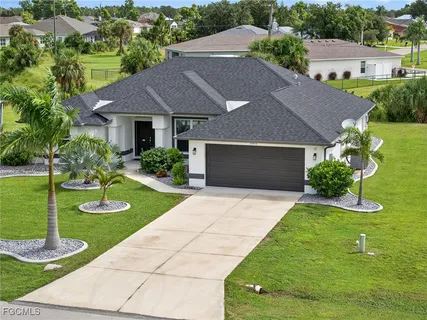 a aerial view of a house with a yard