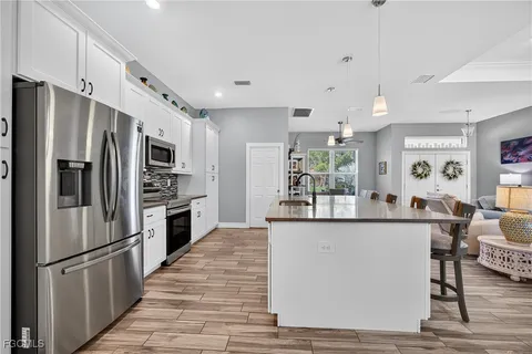 a kitchen with stainless steel appliances a refrigerator and a stove top oven