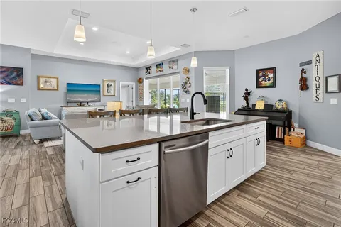 a kitchen with a sink stove and cabinets