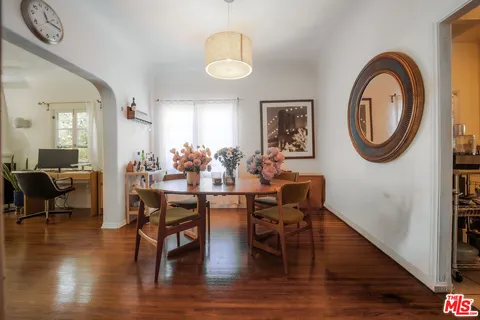 a view of a dining room with furniture and wooden floor