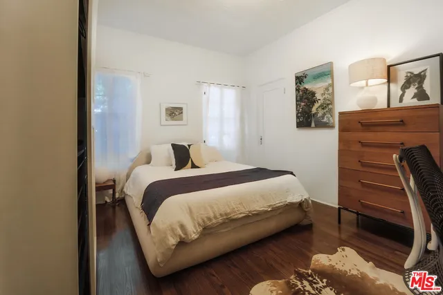 a bedroom with a bed and a night stand