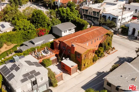 an aerial view of a house with a yard