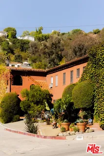 an outdoor sitting area with furniture and wooden floor
