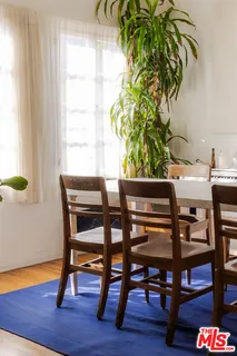 a dining room with furniture and wooden floor