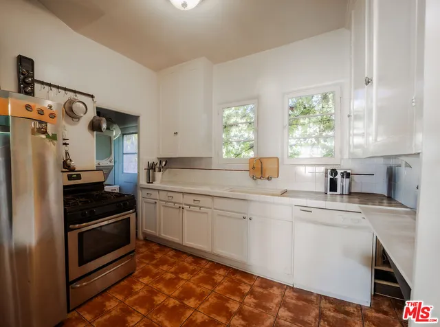 a kitchen with a sink cabinets and window