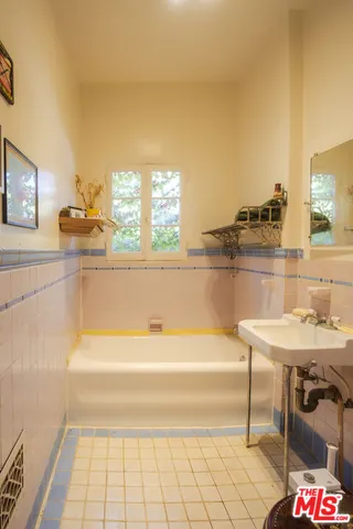 a bathroom with a bathtub and a sink