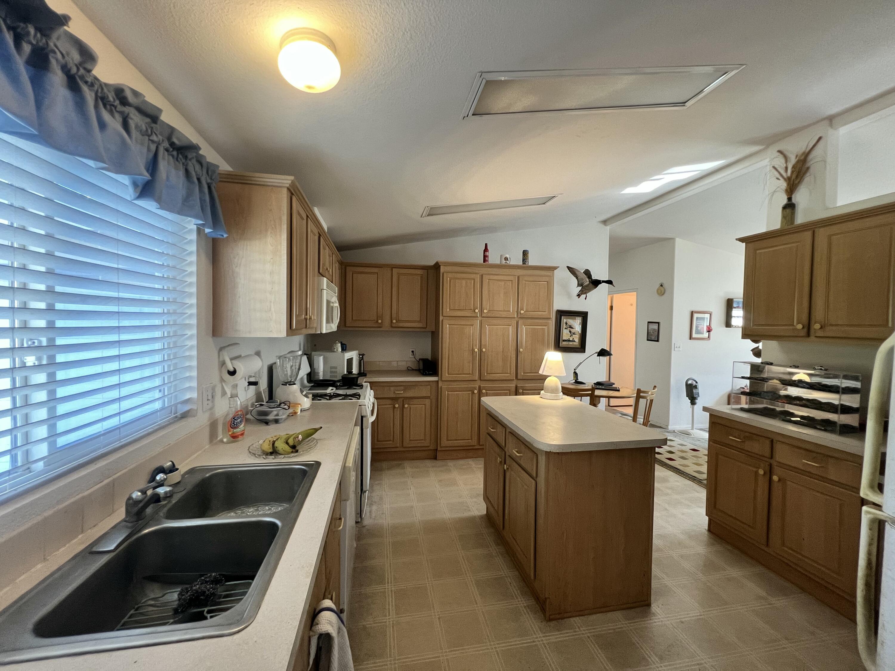 4722 Maple Trail Redding, CA 96003 - Photo 3 of 14 a kitchen that has a sink and a stove in it