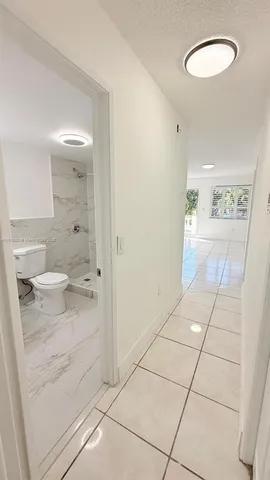 a bathroom with a granite countertop shower and a sink