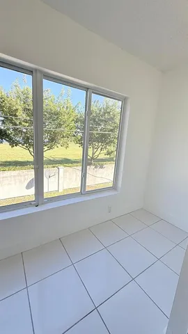 a view of an empty room with a window