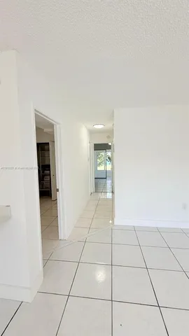 a view of a livingroom with an empty space and a window