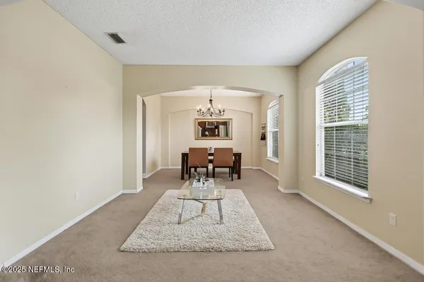 a kitchen with stainless steel appliances granite countertop white cabinets and a stove top oven
