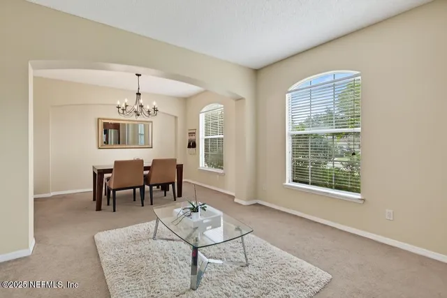 a view of swimming pool with lawn chairs under an umbrella
