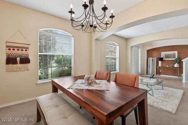 an aerial view of residential houses with outdoor space and river