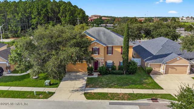 a view of a dining room with a table and chairs