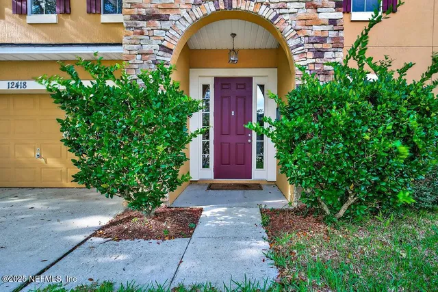 a living room with furniture and floor to ceiling window